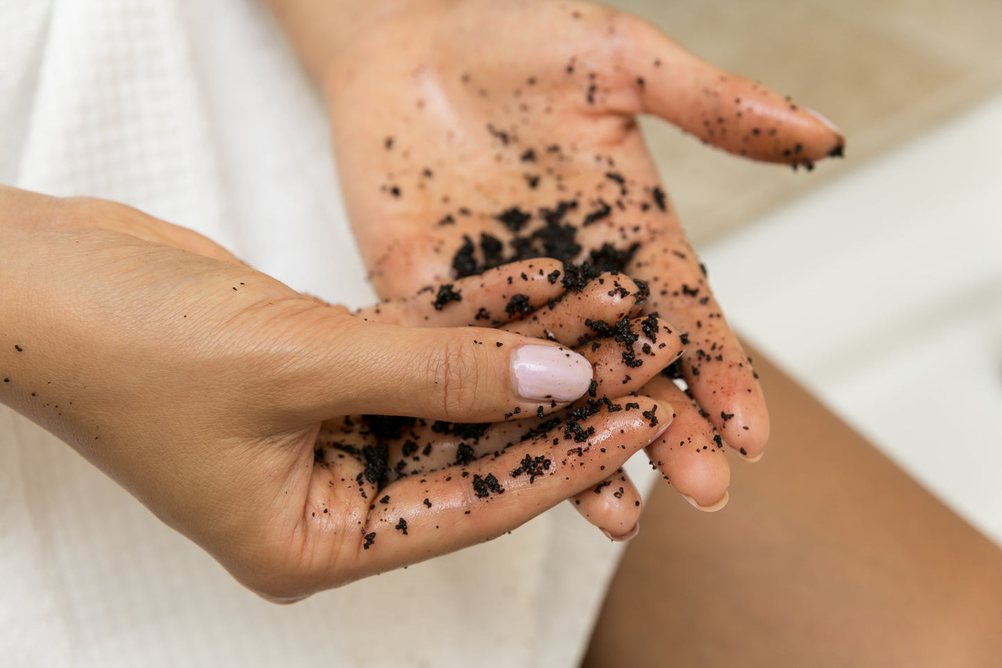 Fivesso Coffee Body Scrub being used on hands, demonstrating its natural exfoliating properties.